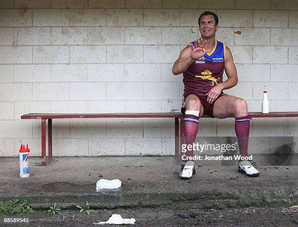 Wayne Carey of the Lions sits on the reserves bench after leaving the field of play injured during the QAFL Pineapple Hotel Cup Division Two match...