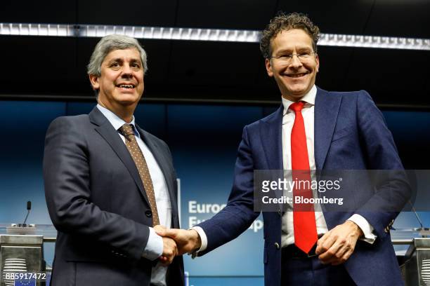 Mario Centeno, Portugal's finance minister and newly-elected head of the group of euro-area finance ministers, left, shakes hands with Jeroen...