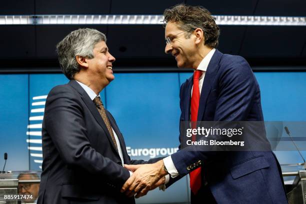 Mario Centeno, Portugal's finance minister and newly-elected head of the group of euro-area finance ministers, left, shakes hands with Jeroen...