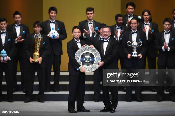 Captain Yu Kobayashi of Kawasaki Frontale receives the J.League J1 Champions Trophy by J.League Chairman Mitsuru Murai during the 2017 J.League...