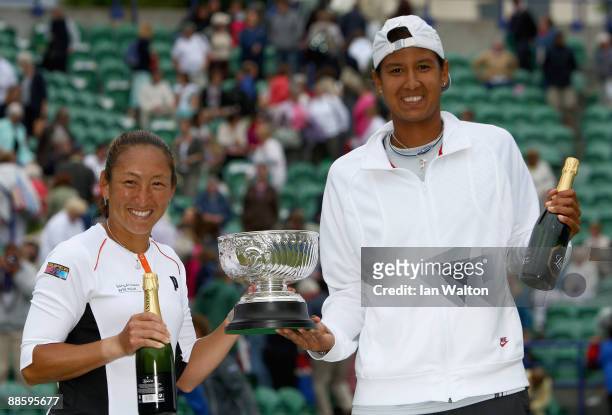 Akgul Amanmuradova of Uzbekistan and Ai Sugiyama of Japan celebrates with the tropy after winning the women's Doubles Final against Rennae Stubbs of...