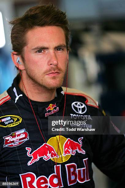 Scott Speed, driver of the Nemo Motorsports Toyota, stands in the garage during practice for the NASCAR Sprint Cup Series Toyota/Save Mart 350 at the...