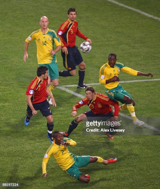 David Villa and Fernando Torres of Spain challenge Siboniso Gaxa and Benson Mhlongo of South Africa for a high ball as Matthew Booth of South Africa...