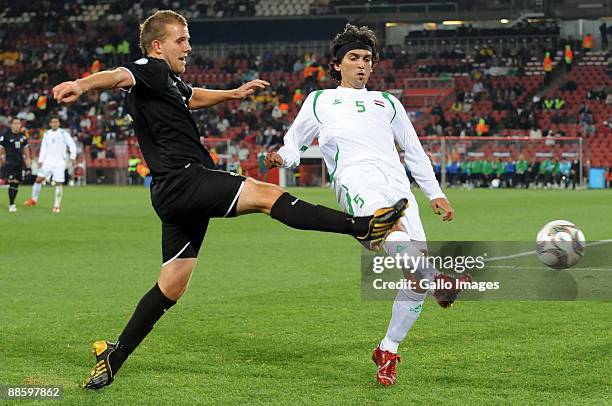 Jeremy Brockie of New Zealand tackles Nashat Akram of Iraq during the 2009 Confederations Cup match between Iraq and New Zealand from Ellis Park...
