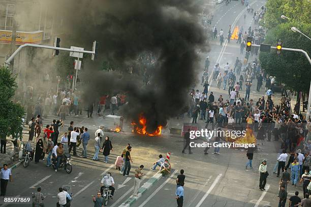 Supporters of Iran's defeated presidential candidate Mir Hossein Mousavi set burning barricades in the streets as they protest during a demonstration...