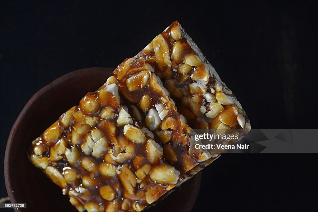 Close-up of Peanut brittle/chikki in a clay bowl-Indian snack