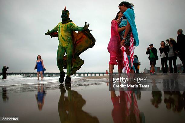 People dressed as mermaids gather by the ocean after marching in the 2009 Mermaid Parade at Coney Island June 20, 2009 in the Brooklyn borough of New...