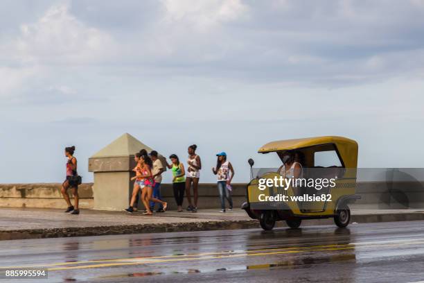 yellow cocotaxi on the malecon - cocotaxi stock pictures, royalty-free photos & images