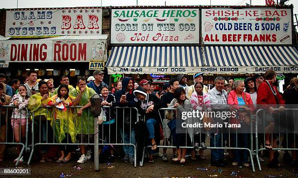 Onlookers watch the 2009 Mermaid Parade at Coney Island June 20, 2009 in the Brooklyn borough of New York City. Actor Harvey Keitel led as "King...