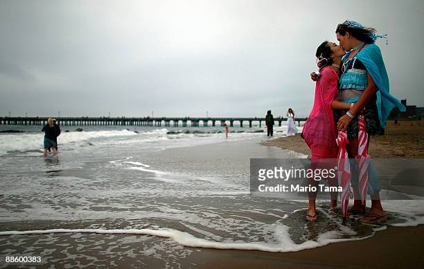 Hamilton and Emiko Harama kiss by the ocean after marching in the 2009 Mermaid Parade at Coney Island June 20, 2009 in the Brooklyn borough of New...