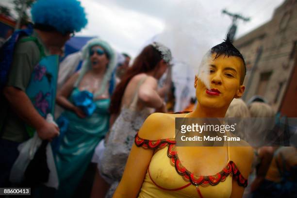 Performers look on before the start of the 2009 Mermaid Parade at Coney Island June 20, 2009 in the Brooklyn borough of New York City. Actor Harvey...