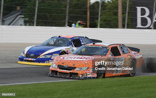 Kyle Busch, driving the Combos Toyota, passes Trevor Bayne, driving the Michael Waltrip Racing Toyota during the NASCAR Nationwide Series...