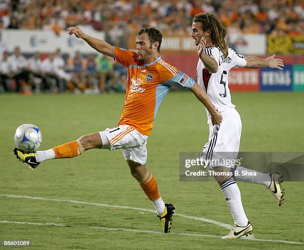 Brad Davis of the Houston Dynamo dribbles the ball against Kyle Berkerman of Salt Lake Real at Robertson Stadium on June 20, 2009 in Houston, Texas.