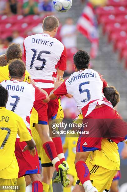 Kyle Davies of the FC Dallas makes a header surrounded by Eddie Gaven and Chad Marshall of the Columbus Crew and Drew Moor and Marcelo Saragosa of...