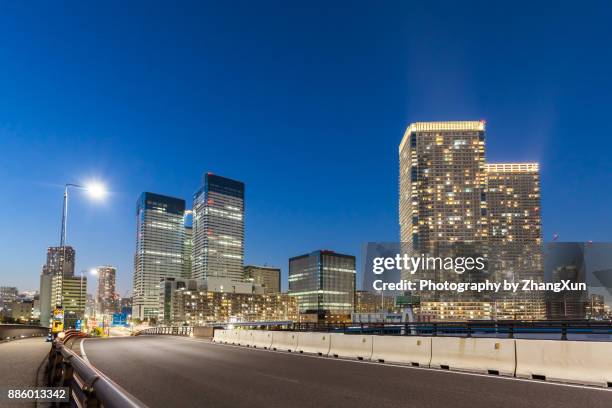 cityscape of tokyo city traffic at night, harumi aera, japan. - harumi district tokyo stock pictures, royalty-free photos & images