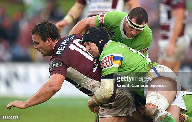 Josh Perry of the Sea Eagles is tackled during the round 15 NRL match between the Manly Warringah Sea Eagles and the Canberra Raiders at Brookvale...