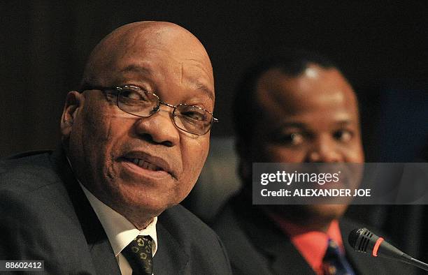 Southern African Development Community chairman, South African President Jacob Zuma speaks as King Mswati of Swaziland looks on, at a press...