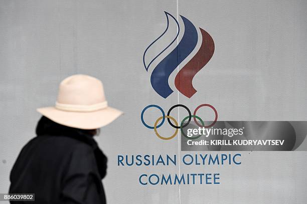 Woman walks in front of the Russian Olympic Committee building in Moscow on December 05, 2017. The International Olympic Committee meets from...