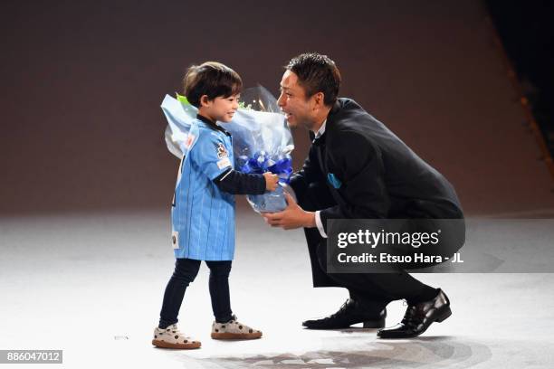 Yu Kobayashi of Kawasaki Frontale celebrates the J.League Player of the Year Award with his child during the 2017 J.League Awards at Yokohama Arena...