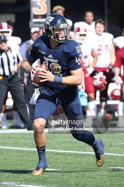 Alex McGough of the Florida International Golden Panthers runs out of the pocket with the ball against the Massachusetts Minutemen on December 2,...
