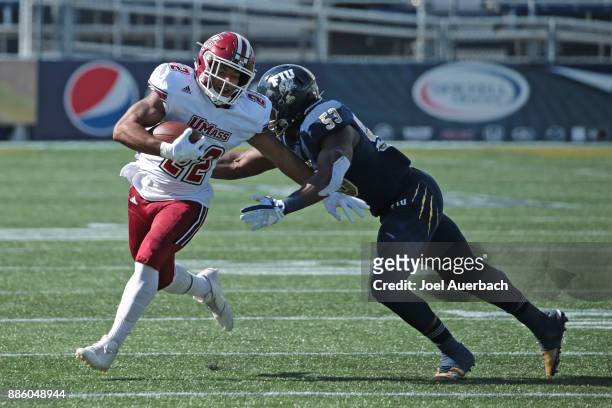 Anthony Wint of the Florida International Golden Panthers tackles Bilal Ally of the Massachusetts Minutemen as he runs with the ball on December 2,...