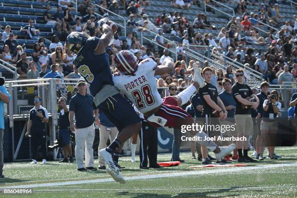 Bryce Singleton of the Florida International Golden Panthers catches the ball for a touchdown while being defended by Jackson Porter of the...