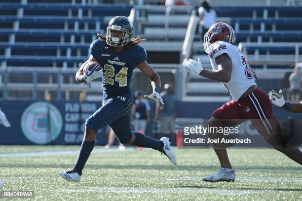 Vonte Price of the Florida International Golden Panthers runs with the ball against the Massachusetts Minutemen on December 2, 2017 at Riccardo Silva...