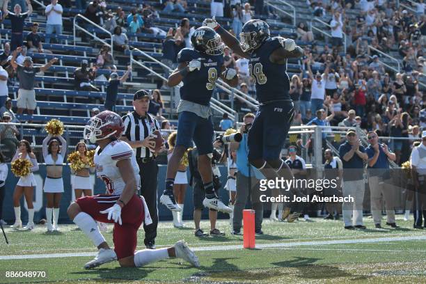 Bryce Singleton of the Florida International Golden Panthers celebrates his touchdown against the Massachusetts Minutemen with Pharaoh McKever on...