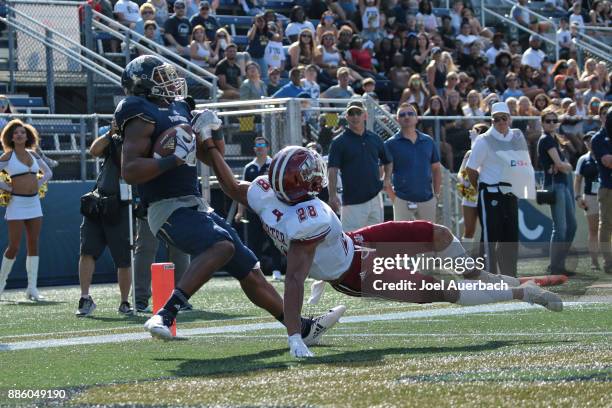 Bryce Singleton of the Florida International Golden Panthers catches the ball for a touchdown while being defended by Jackson Porter of the...