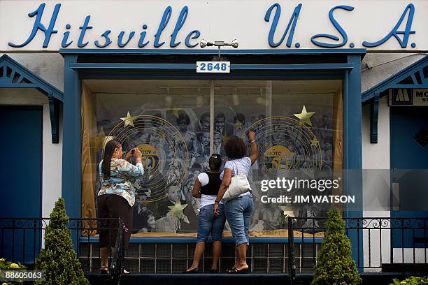 By Rob Lever, Entertainment-US-music-company-Motown Three women look over the window display at the Motown Museum in Detroit, Michigan, June 16,...