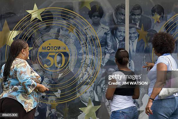 By Rob Lever, Entertainment-US-music-company-Motown Three women look over the window display at the Motown Museum in Detroit, Michigan, June 16,...