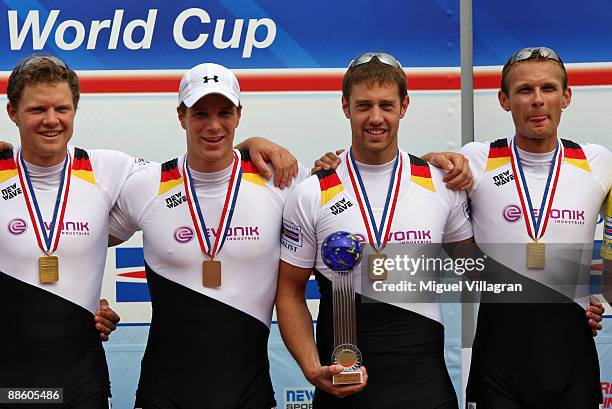 Philip Adamski, Urs Kaeufer, Richard Schmidt and Kristof Wilke of team Germany 2 pose with the trophy after winning the Men's Double Sculls Final of...