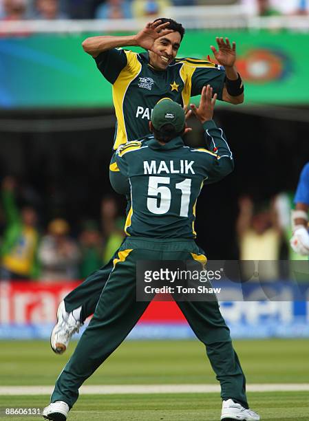 Umar Gul of Pakistan celebrates the wicket of Chamara Silva of Sri Lanka with Shoaib Malik during the ICC World Twenty20 Final between Pakistan and...