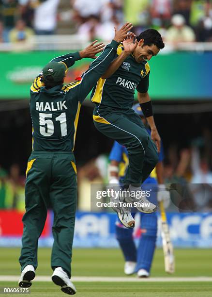 Umar Gul of Pakistan celebrates the wicket of Chamara Silva of Sri Lanka with Shoaib Malik during the ICC World Twenty20 Final between Pakistan and...