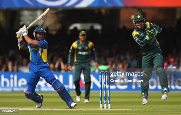 Kumar Sangakkara of Sri Lanka hits out as Kamran Akmal of Pakistan takes evasive action during the ICC World Twenty20 Final between Pakistan and Sri...