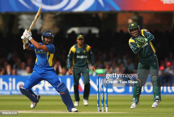 Kumar Sangakkara of Sri Lanka hits out as Kamran Akmal of Pakistan takes evasive action during the ICC World Twenty20 Final between Pakistan and Sri...