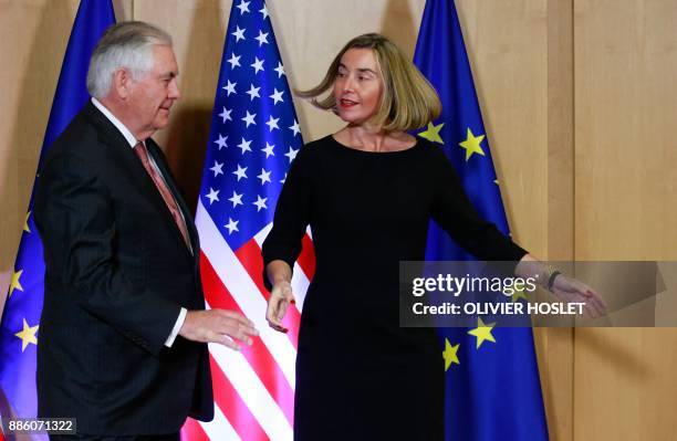 Secretary of State Rex Tillerson shakes hands with EU foreign policy chief Federica Mogherini at the European Union Council building in Brussels on...