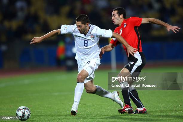 Clint Dempsey of the USA is challenged by Mohamed Aboutrika of Egypt during the FIFA Confederations Cup match between Egypt and USA at Royal Bafokeng...