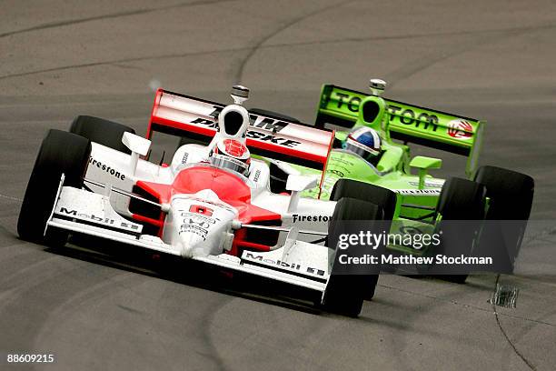 Ryan Briscoe, driver of the Team Penske Dallara Honda, leads Dario Franchitti, driver of the TomTom Target Chip Ganassi Racing Dallara Honda, during...