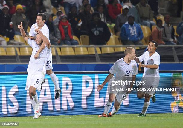 Midfielder Clint Dempsey celebrates with US midfielder Benny Feilhaber , US midfielder Michael Bradley and US forward Charlie Davies after scoring...