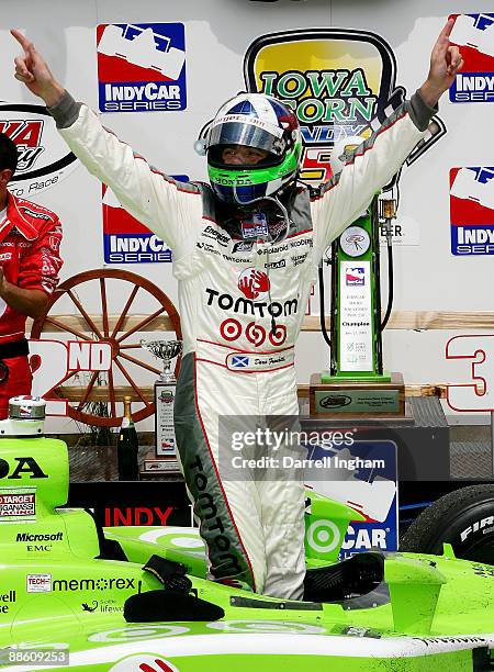 Dario Franchitti climbs out of the TOM TOM Target Chip Ganassi Racing Dallara Honda to celebrate winning the IRL Indycar Series Iowa Corn Indy 250 on...