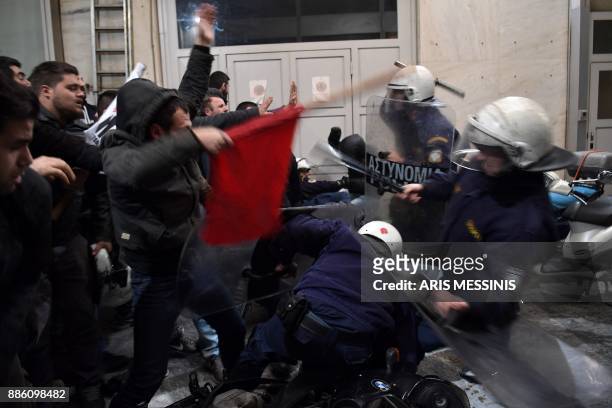 Members of the Greek Communist labour union clash with riot police after entering the Greek labour ministry during a demonstration against the...