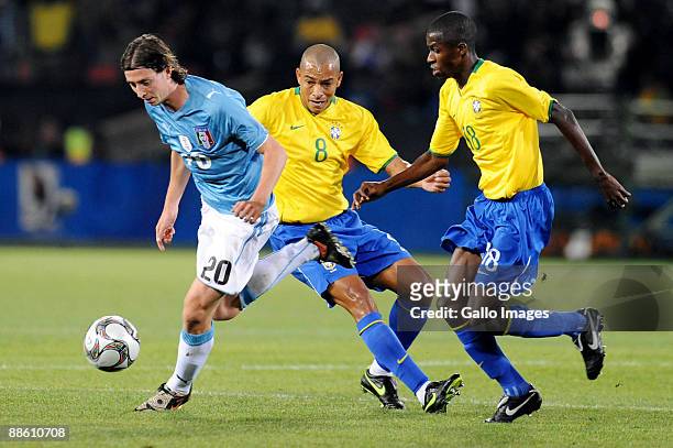 Riccardo Monotolivo of Italy,Gilberto Silva and Ramires of Brazil vie for the ball during the FIFA Confederations Cup match between Italy and Brazil...