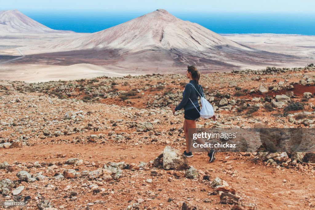 Young woman hiking with panoramic view on volcano