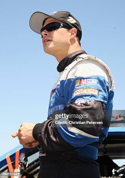 David Gilliland, driver of the Adobe Road Winery Chevrolet, stands on the grid prior to the start of the NASCAR Sprint Cup Series Toyota/Save Mart...