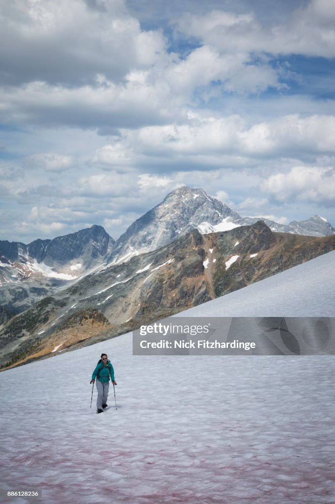 A person snowshoeing uphill approaching Asulkan Pass, Glacier National Park, British Columbia, Canada