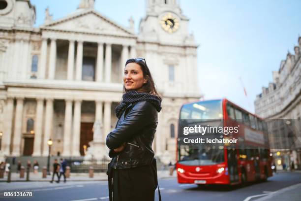 young woman walking on a sunny day in london, near st paul's cathedral - st paul's cathedral london stock pictures, royalty-free photos & images