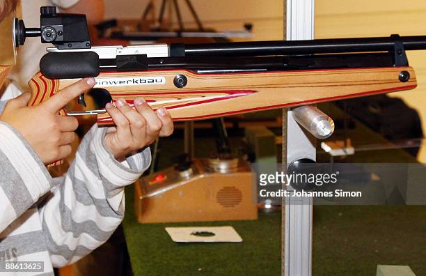 Young boy tests sporting arms during a familiy open day of shooting club 'Gut Ziel' on June 21, 2009 in Olching-Geiselbullach, Germany. After...