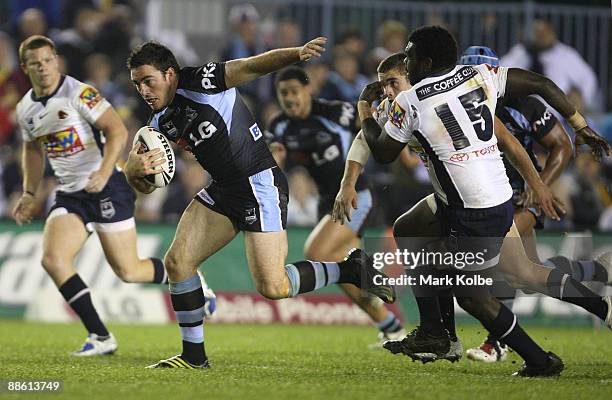 Grant Millington of the Sharks breaks the defence on his way to scoring a try during the round 15 NRL match between the Cronulla Sharks and the...