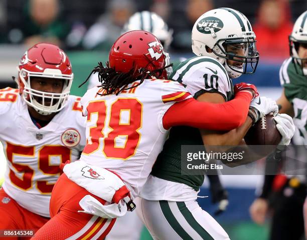 Jermaine Kearse of the New York Jets carries the ball for the first down as Ron Parker of the Kansas City Chiefs makes the tackle in the first...